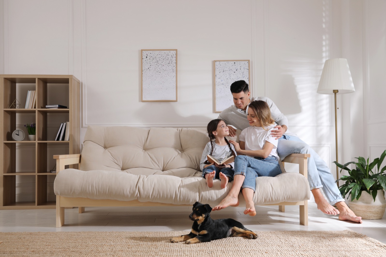 A family on their couch with a foster puppy