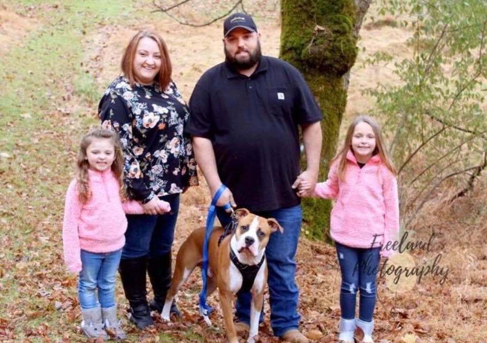 A newly adopted pet with their family