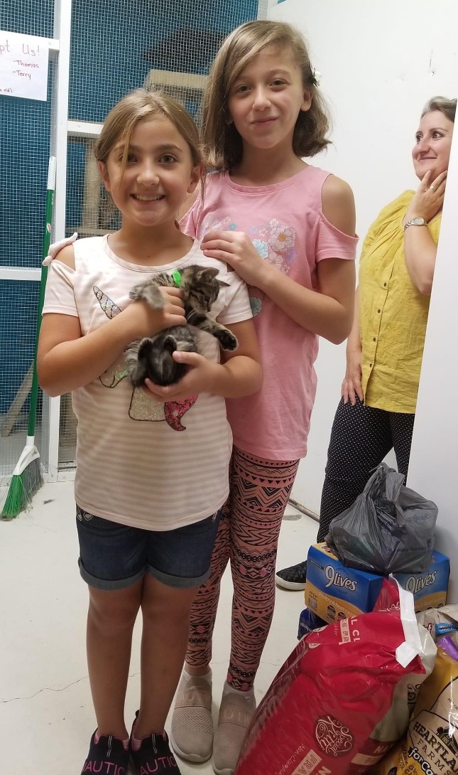 A newly adopted pet with their family